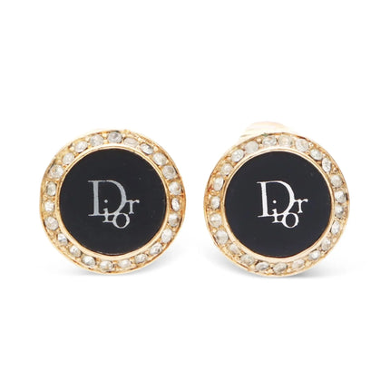 Christian Dior round earrings with rhinestones around outer circle of earring and inner circle is black filled with white Dior logo in center