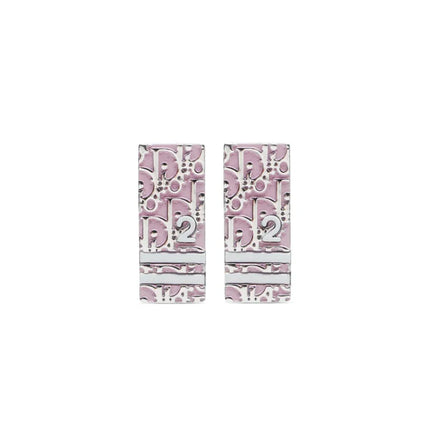 Clip on Dior trotter earrings with Dior monogram the number 2 and 2 stripes across earrings in pink and white enamel inlay